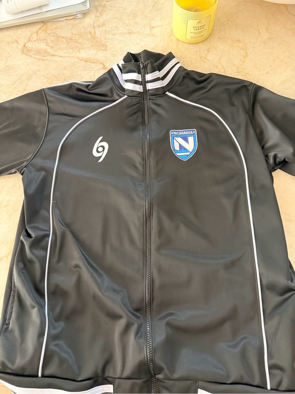 New Balance Black Track Jacket with White Piping and Blue Nicaragua Crest